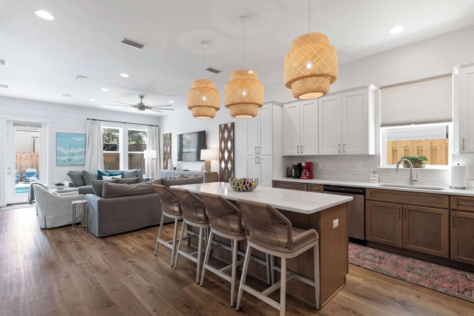 Open kitchen & dining area w/ pendant lights & room to gather
