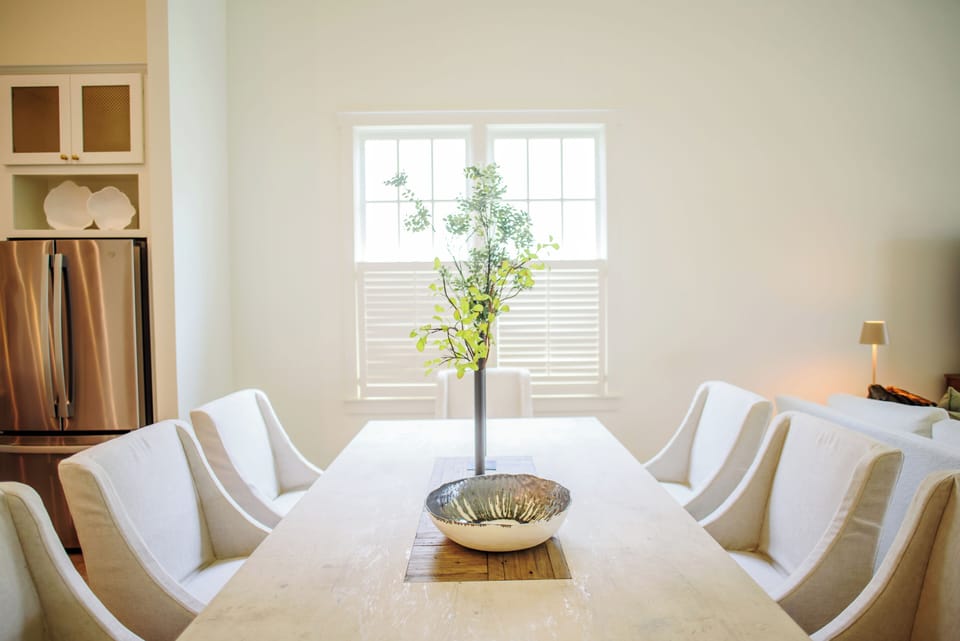 Large dining room table with rolling chairs