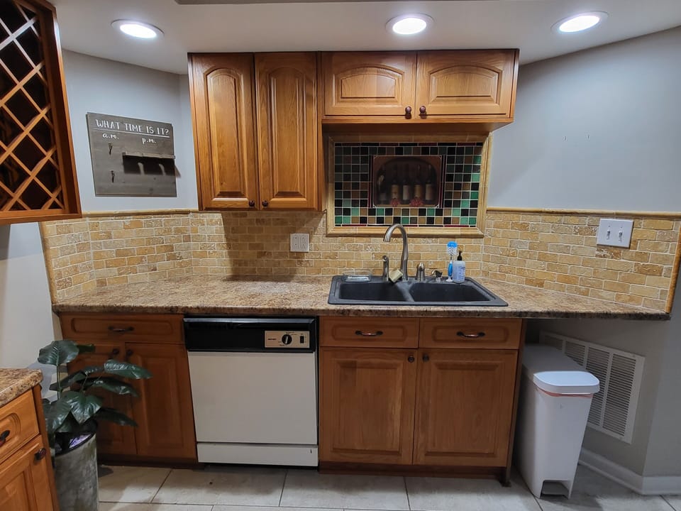 Large kitchen with full size appliances including dishwasher, smooth top range, microwave and side by side refrigerator
