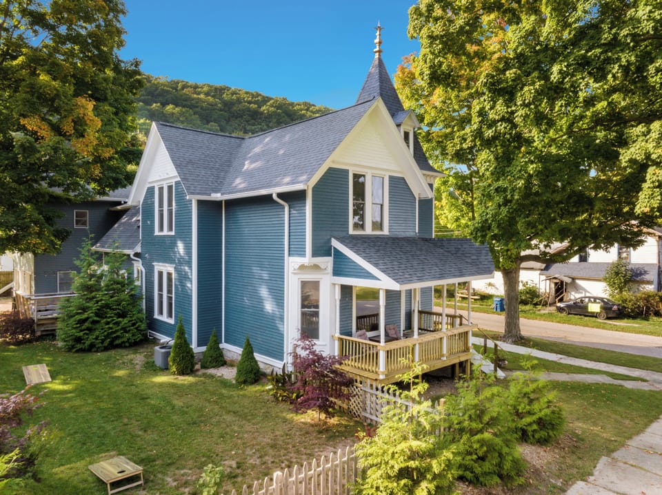 OVERVIEW:  The front and east isde of the of the house (including fenced-in backyard) in summer.