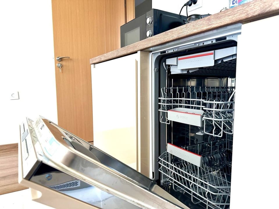 Experience the convenience of modern living with a state-of-the-art dishwasher, seamlessly integrated into the kitchen's sleek design. Perfect for effortless cleanup, leaving you more time to enjoy your stay.