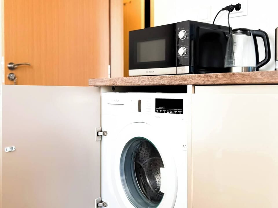 Enjoy the convenience of in-unit laundry with this modern washer, discreetly tucked away in the kitchen. Whether you're staying for a weekend or an extended visit, this feature ensures your stay is as comfortable and hassle-free as possible.