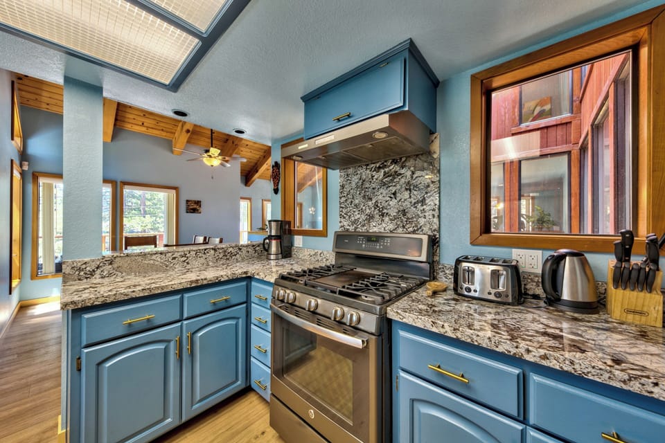 Cook your favorite meals in this stunning kitchen featuring granite counters, modern appliances, and skylights that fill the space with natural light.