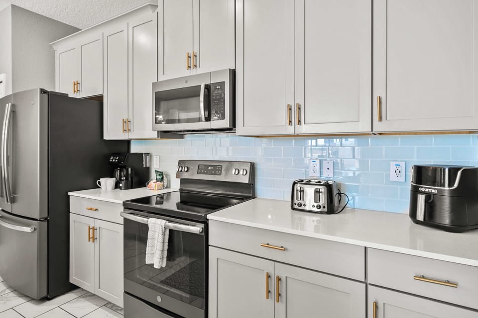 - Sleek and modern kitchen equipped with top-of-the-line appliances and stylish cabinetry - Prepare meals with ease in this bright, functional, and beautifully designed space - The perfect blend of elegance and practicality for culinary creativity