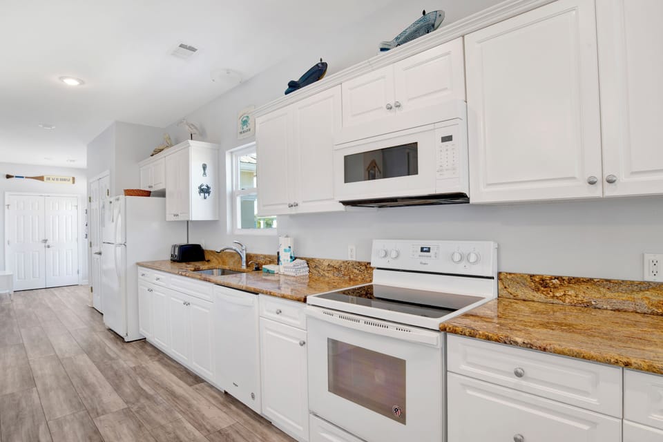 Kitchen with granite countertops plus large and small appliances