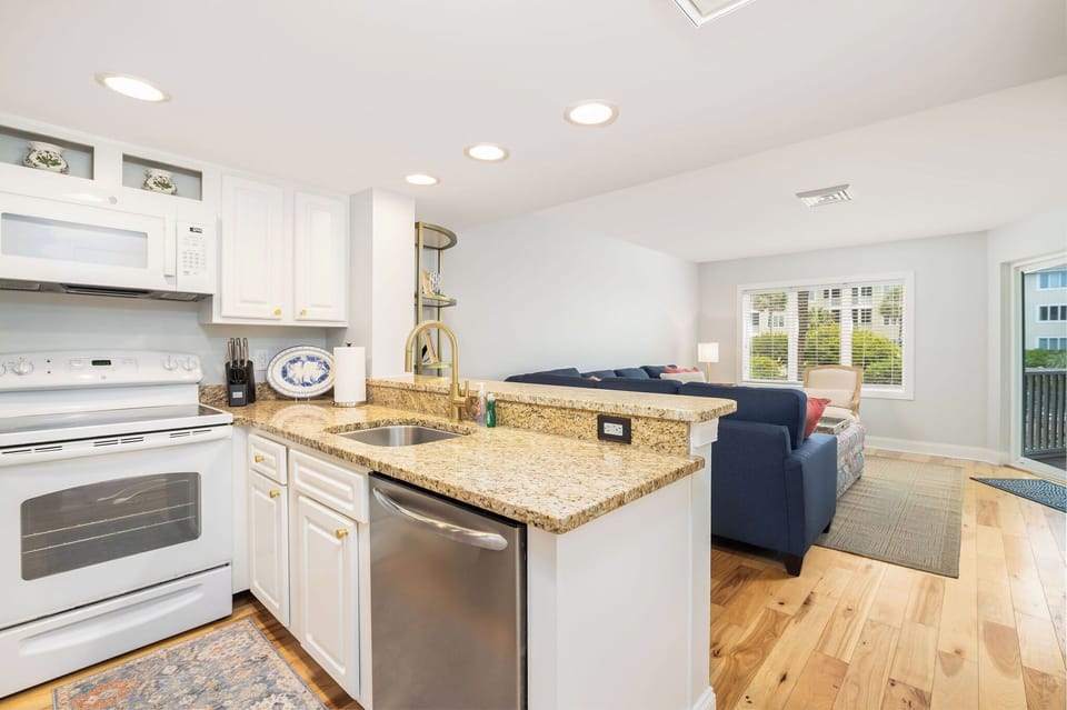 Inviting fullly equipped kitchen with updated finishes — steps from the beach