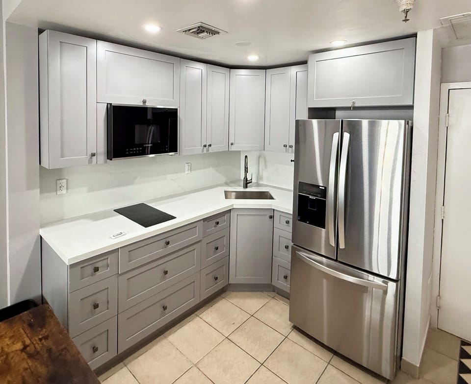 New kitchen including cooktop, microwave, fridge