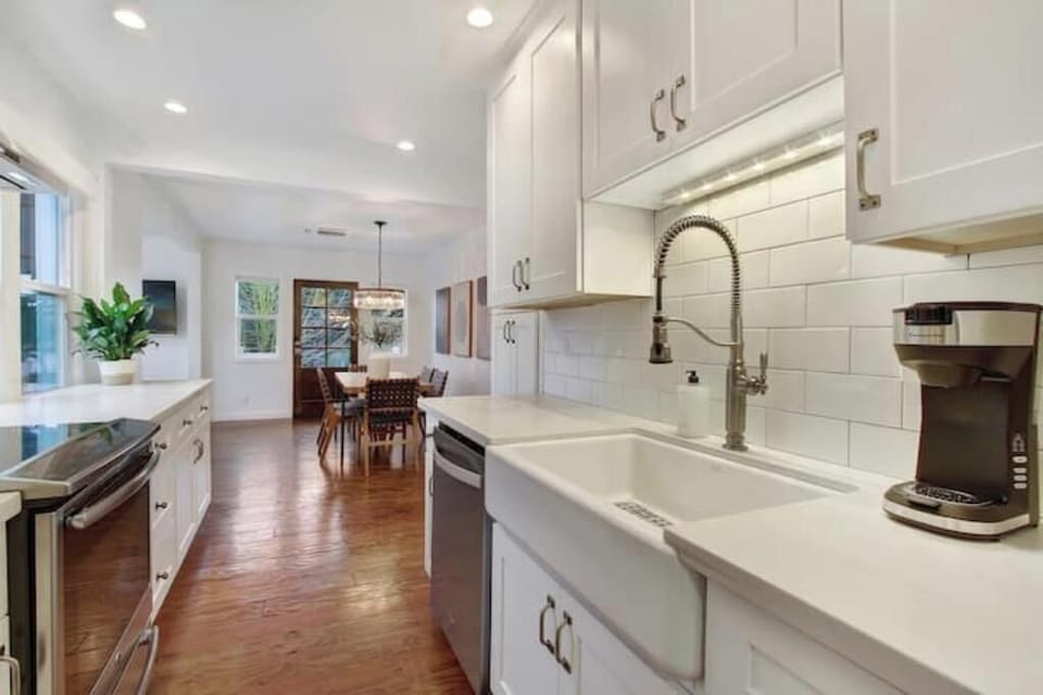 Kitchen opens to dining area, fully equipped with farm sink, Keurig & basics.