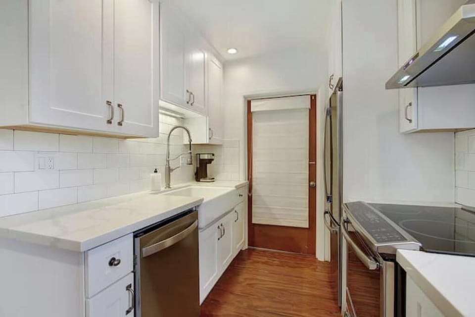 Cabinets stocked with basics and a tall pantry for extra storage.