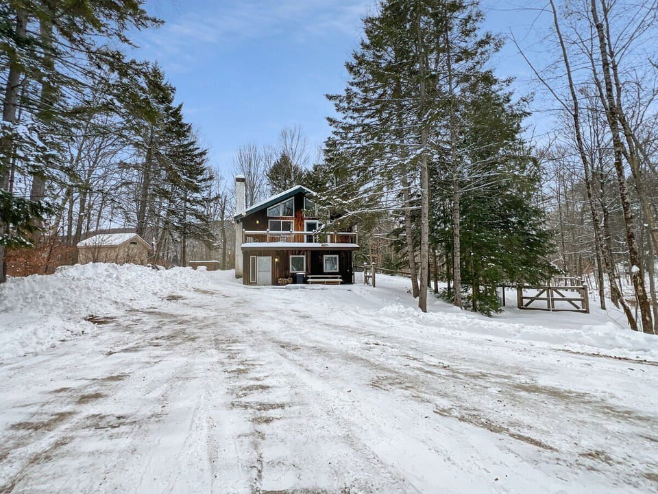 Seasonal exterior view showing the home and driveway in winter conditions.