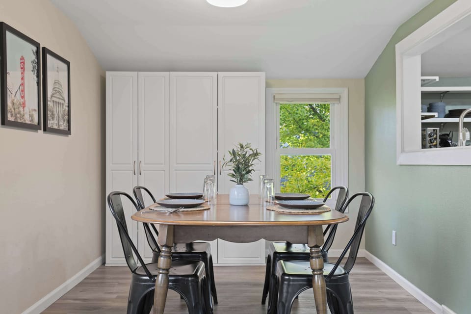 Dining room with 4 spots, and ample storage with floor to ceiling storage shelves.