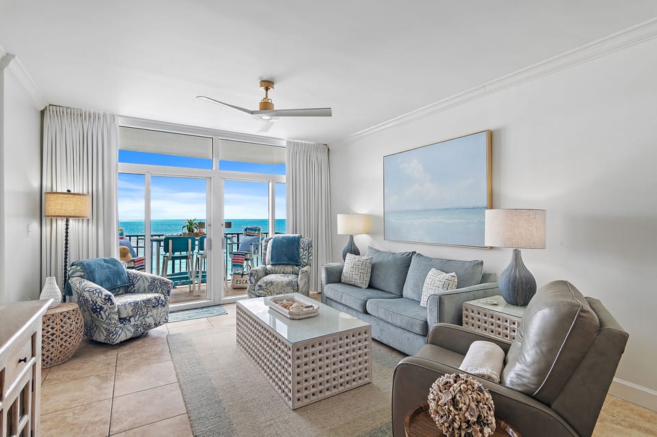 Relax in your coastal sanctuary where ocean blues meet comfortable seating and stunning sea views stretch endlessly beyond your private balcony.