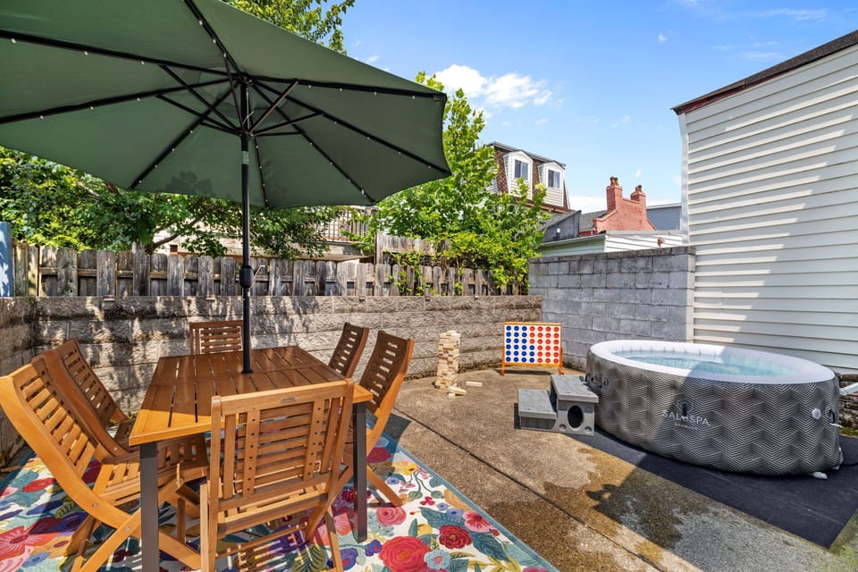 Backyard patio with inflatable hot tub and dining area