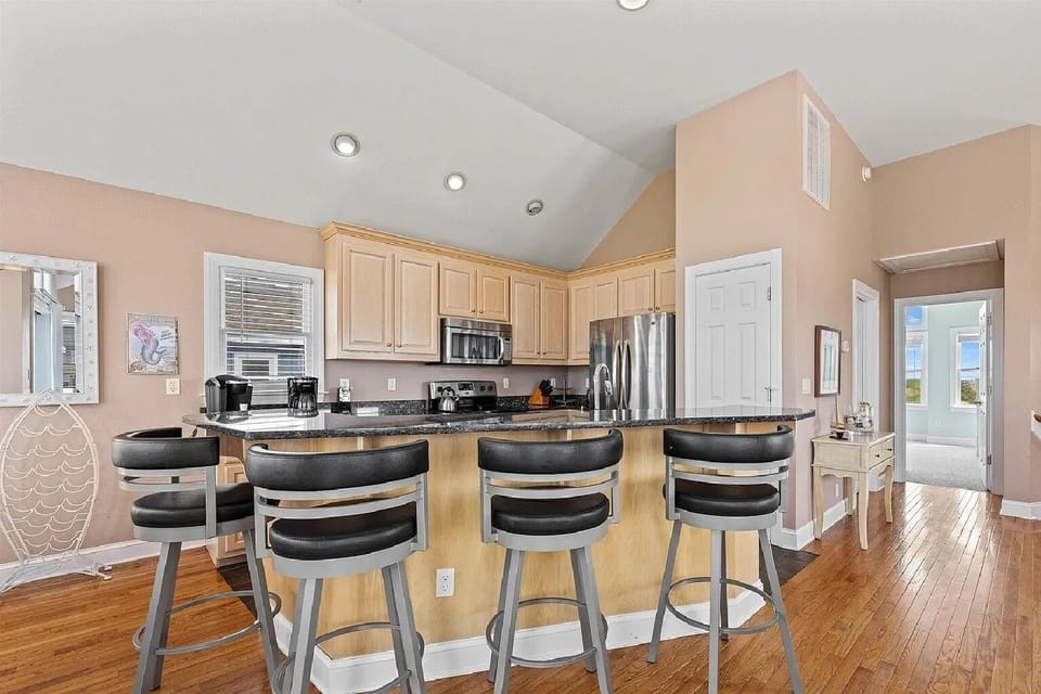 Kitchen with Bar Stool Seating on Third Level