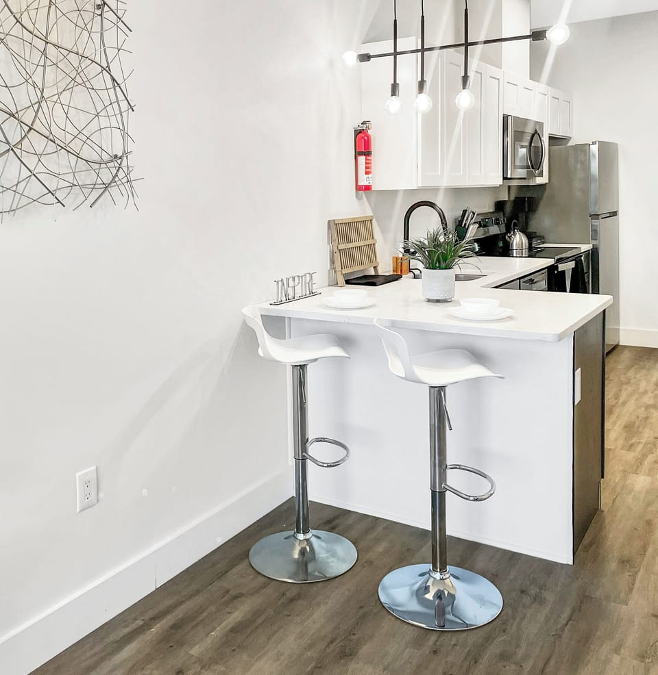 Open-concept kitchen, including breakfast bar and adjustable height stools
