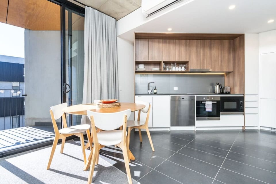 Spacious kitchen and dining area bathed in natural light, offering a bright and welcoming space for cooking and dining. Perfect for gathering and enjoying meals with a view.