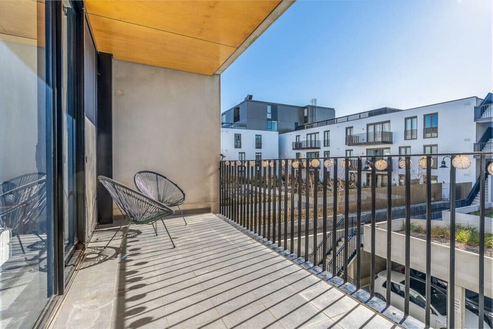 Charming balcony with two comfortable seating areas, perfect for relaxing and enjoying the outdoors. A peaceful spot to unwind with a book or take in the fresh air.
