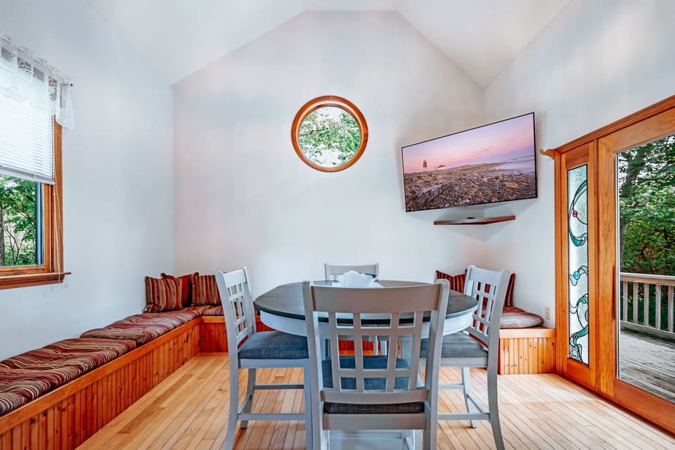 Spacious event room with table, chairs, and 40" HD Smart TV. 