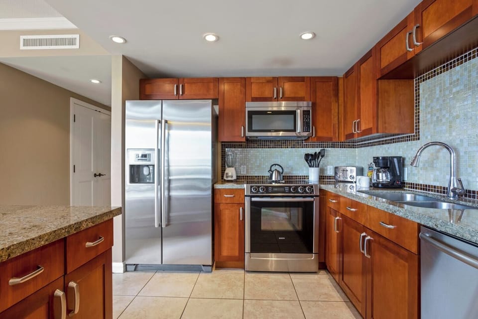Your kitchen features granite counters, stainless steel appliances, and generous workspace, making it easy to prepare snacks before heading to the beach.