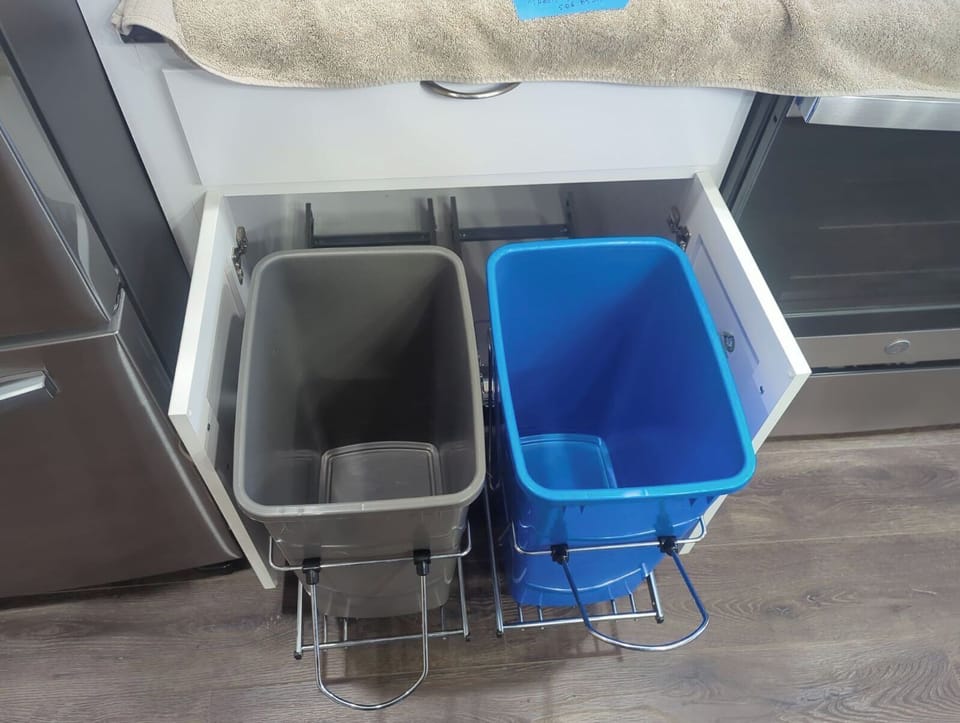 Trash and recycling.  Trashbags in drawer above