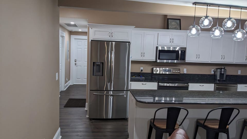 Kitchen, stainless steel appliances, granite counters, island with 4 chairs