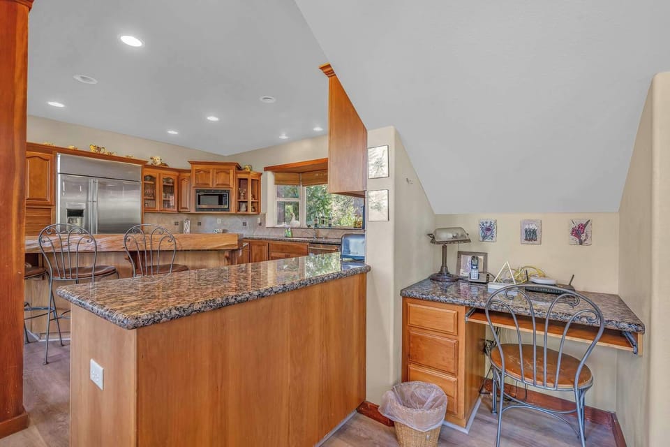 A convenient desk workspace awaits just off the kitchen