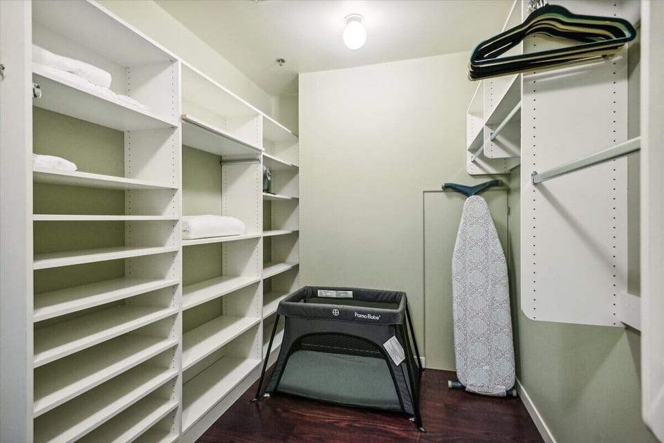 Spacious closet with Pack 'n Play and linens.
