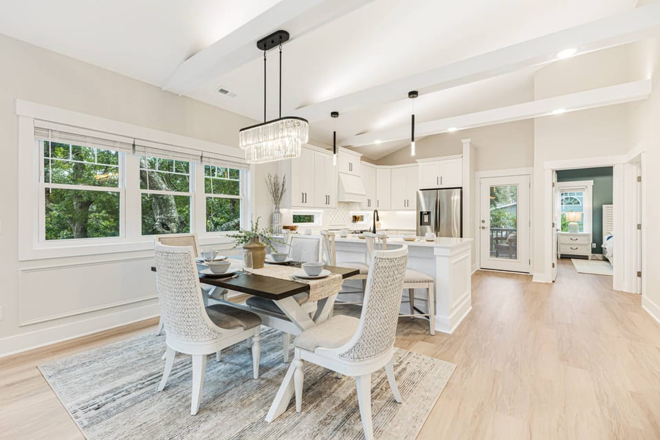The dining area, breakfast bar, and kitchen come together.