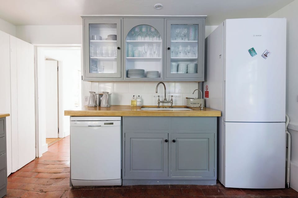 Bright and airy kitchen with a large fridge and dishwasher, making your stay convenient and comfortable
