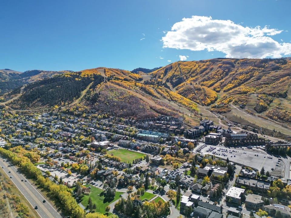 Aerial view of Woodside view, including neighborhoods, roads and mountains.