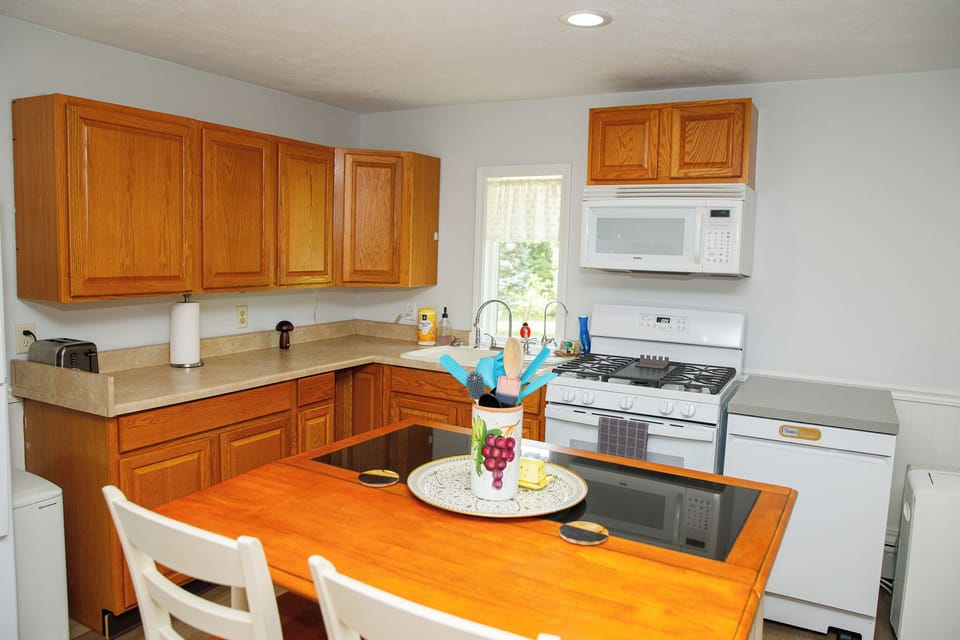 Gas range and oven. Microwave and portable dishwasher.
