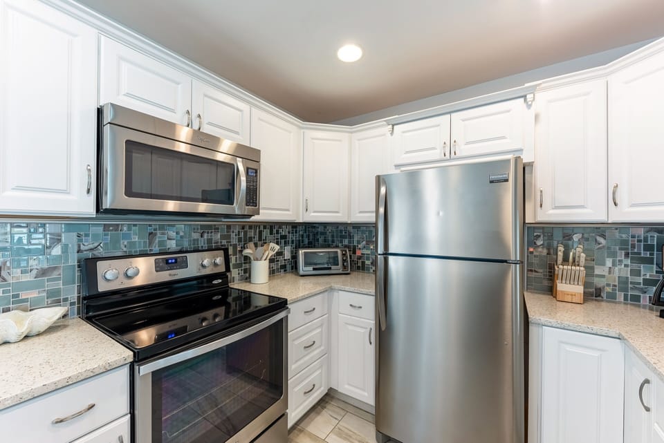 Electric stove and plenty of pots, frying pans, roasting and baking pans