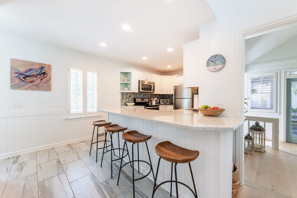 The spacious kitchen island comfortably seats 4, perfect for casual meals