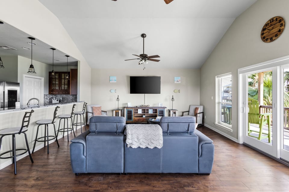 This living room features a couch, TV and extra eating area.
