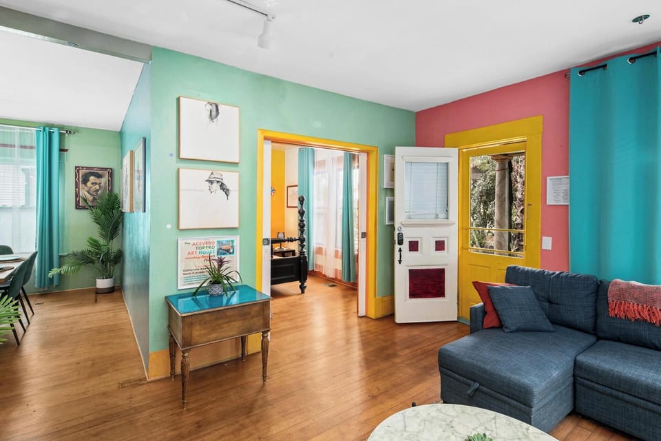 Living Area, Bright front room with colorful walls, sectional seating and art books