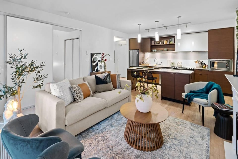 A broad, inclusive look at the great room, showcasing how effortlessly the living lounge connects to the kitchen area.