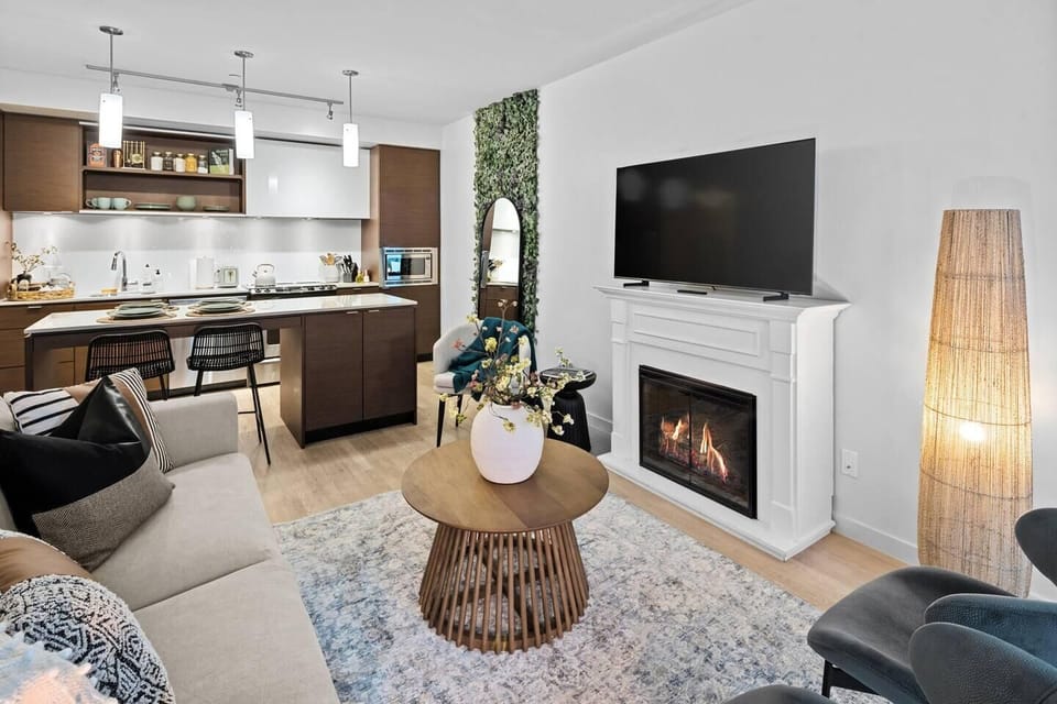 Another perspective of the living space, emphasizing the warm lighting, contemporary design accents, and comfortable open layout.
