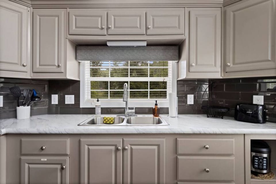 Kitchen is stocked with all necessary cooking appliances, dishware and pots and pans.