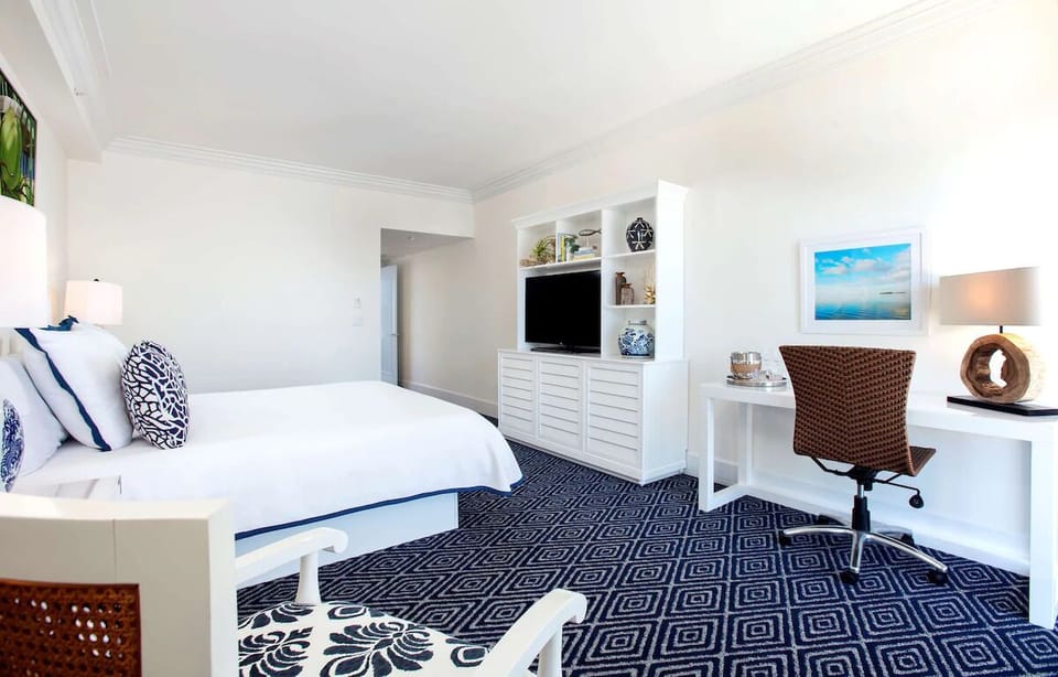 Unwind in a spacious bedroom with desk and lounge seating.