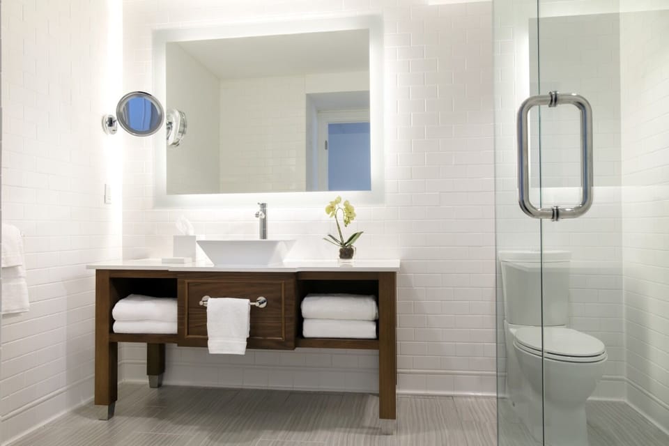 Refresh in a spotless, modern bathroom with glass shower.