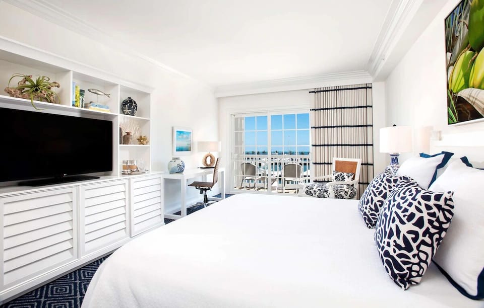 Wake up refreshed in a bright suite with breezy balcony views.