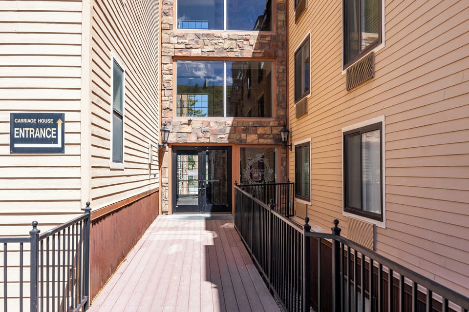 Covered exterior walkway leading to the building entrance, providing convenient and protected access year-round.