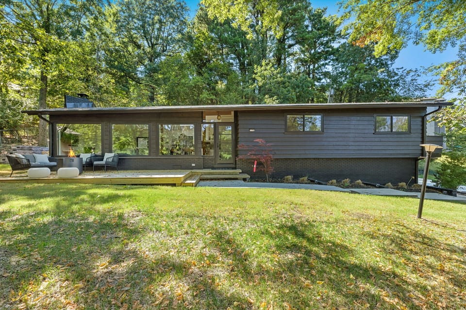 A meticulously designed modern home that is filled with large windows and natural views.