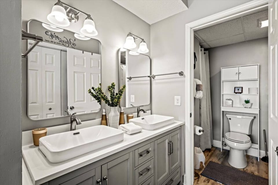 There is a double vanity with all-new fixtures, new toilet, and shower-tub combo.