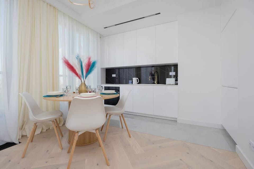 Dining area with open kitchen – Perfect spot for morning coffee or casual dining.

