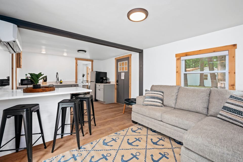 Bright space with nautical decor, comfy seating, and bar-style dining. Perfect for gatherings!