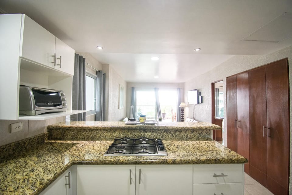 Bright kitchen with granite countertops and modern appliances