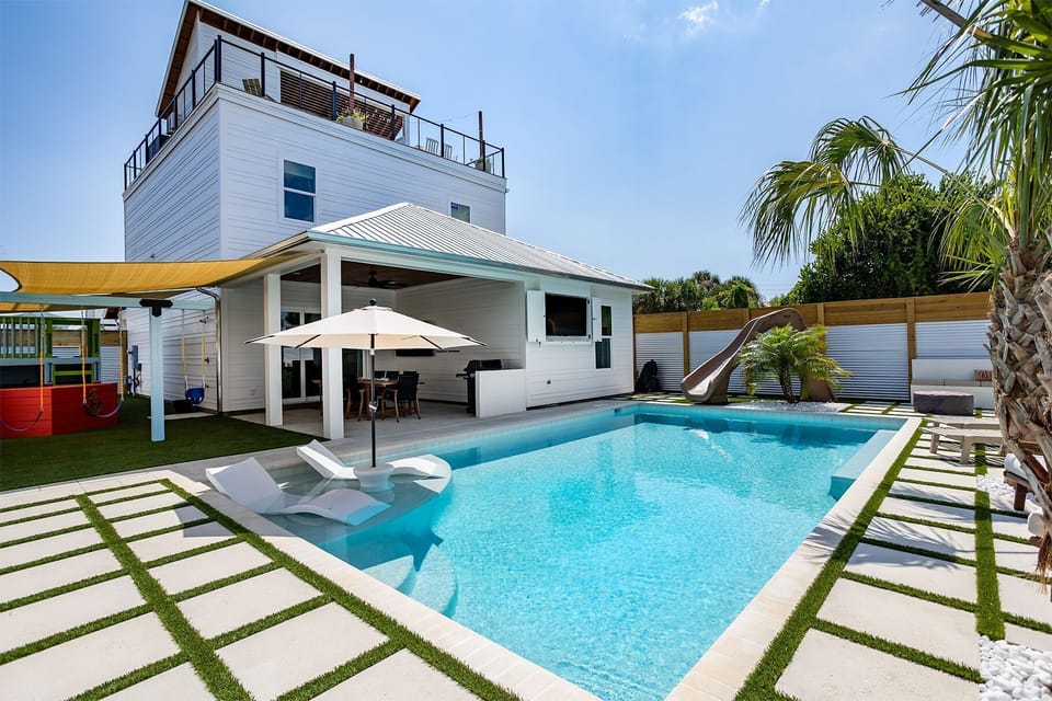 Salt water pool with optional heating, pool slide, sun ledge, and 75" 4k tv