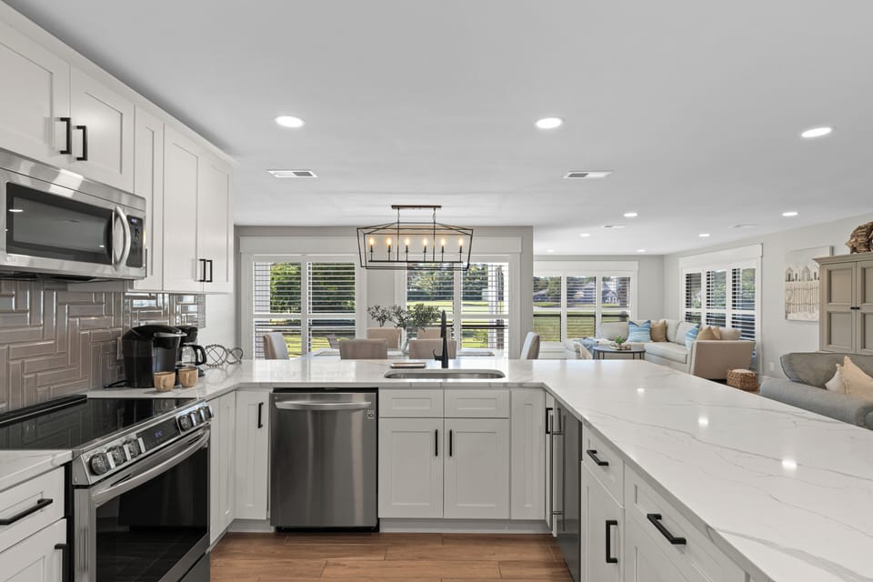 The kitchen comes with a glass top stove range, dishwasher, coffee pot, Keurig, refrigerator w/ an ice make, microwave and wine cooler.