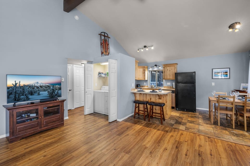 Step into your cozy mountain retreat with vaulted ceilings and charming wood beams. Relax in the open living space with a large TV, then whip up meals in your fully equipped kitchen. Everything you need for a perfect getaway.